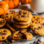 Stack of soft and chewy pumpkin chocolate chip cookies with melted chocolate chips on top